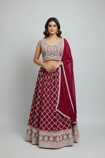 Woman wearing maroon and beige embroidered Indian lehenga with sleeveless blouse and matching dupatta