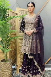 Woman wearing a purple heavily embroidered Indian ethnic suit with matching dupatta at Anandi Fashions boutique