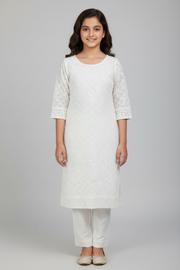 Woman wearing a white kurta with a plain background