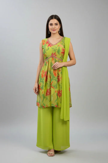 Woman wearing lime green floral sleeveless kurti with matching palazzo pants and dupatta in studio